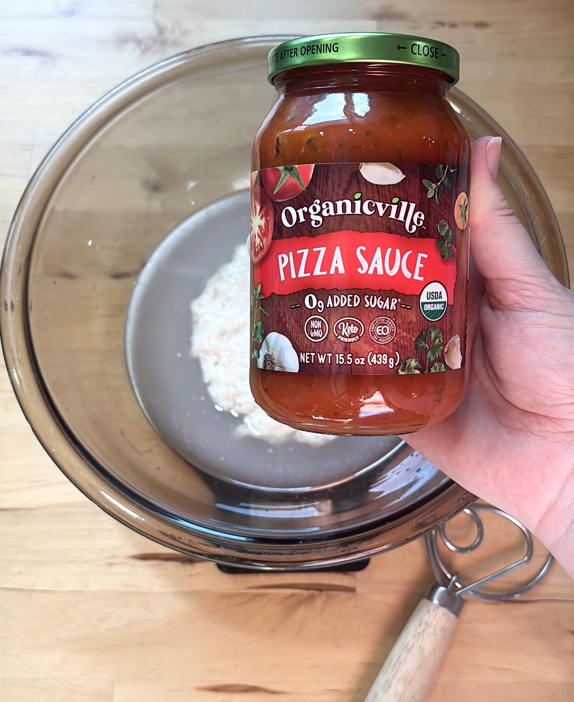 adding pizza sauce to my dough