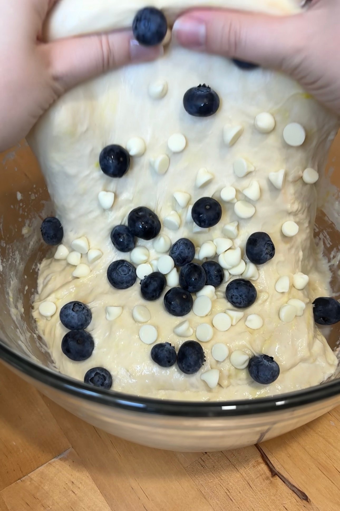 adding blueberries and cream cheese chips into Lemon Blueberry Sourdough Loaf dough 