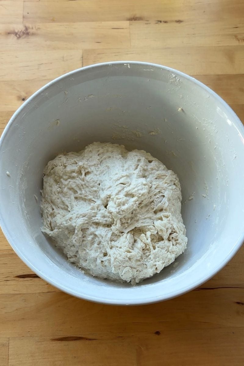 example of shaggy sourdough dough in a white bowl