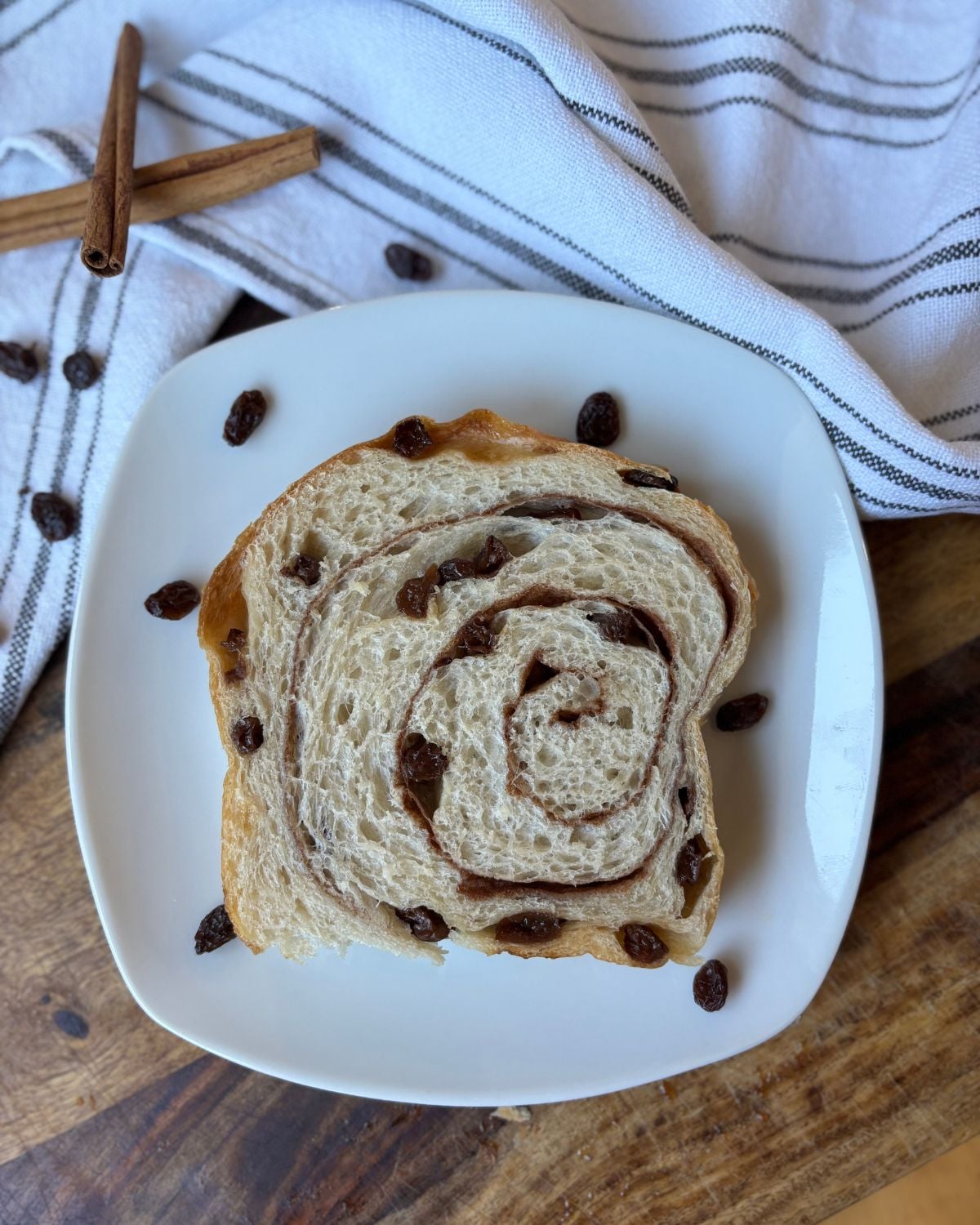 a slice of Soft Sourdough Cinnamon Raisin Swirl Bread